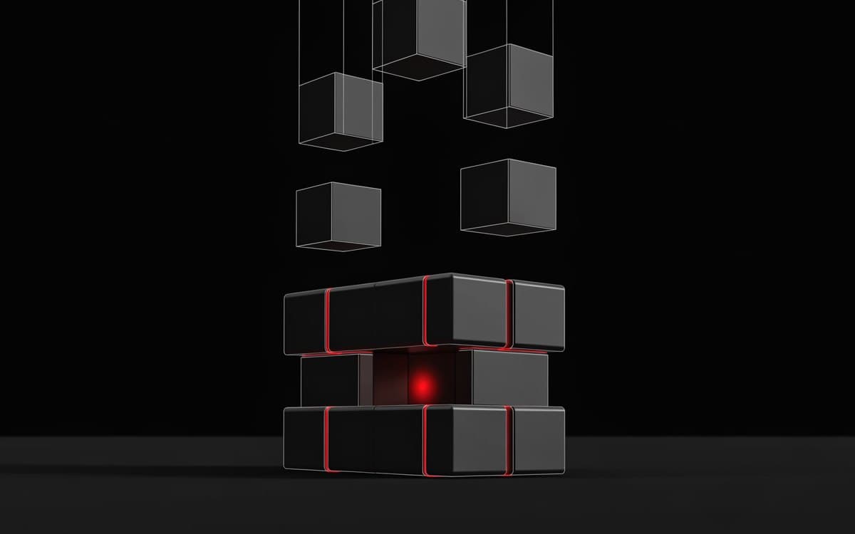 Obsidian blocks locking together into a running machine, crimson light along the joined seams and a lit core.